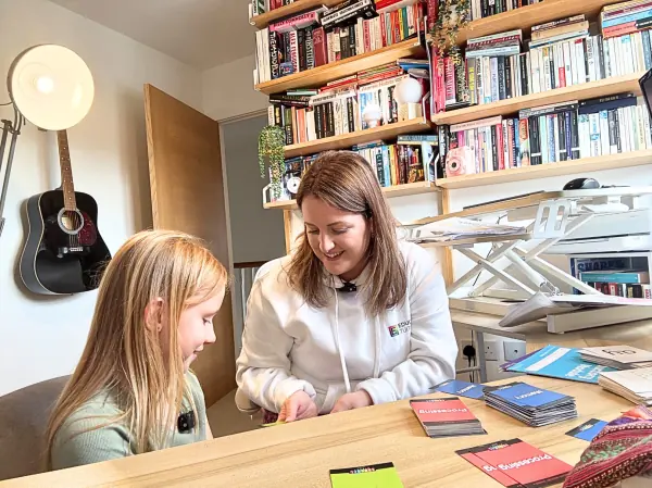 An Educamus Tuition tutor reading with a primary pupil